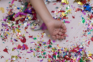 Image showing Children\'s hand with confetti in background