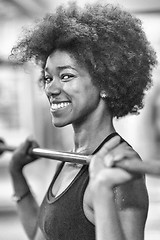 Image showing black woman lifting empty bar