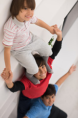 Image showing young boys posing line up piggyback top view