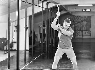 Image showing man workout with hammer and tractor tire