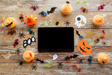 Image showing tablet pc, halloween party decorations and treats