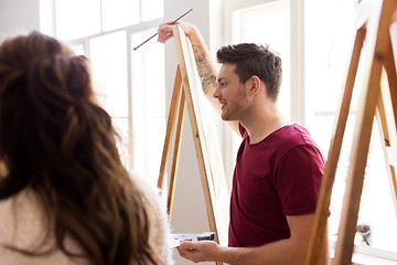 Image showing artists with easels painting at art school