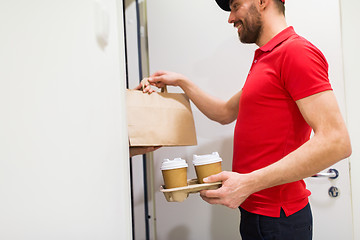 Image showing delivery man with coffee and food at customer home
