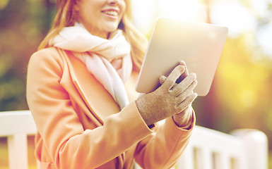 Image showing close up of woman with tablet pc in autumn park