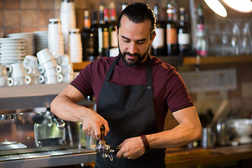 Image showing barista man making espresso at bar or coffee shop