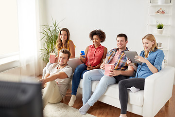 Image showing friends with gadgets and beer watching tv at home