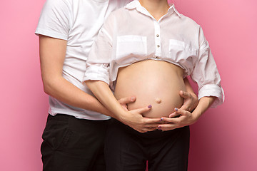 Image showing The handsome man and his beautiful pregnant wife\'s tummy