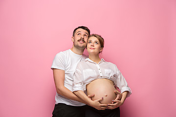 Image showing The handsome man and his beautiful pregnant wife\'s tummy