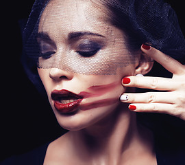 Image showing beauty brunette woman under black veil with red manicure close up