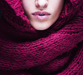 Image showing young pretty woman lips in sweater and scarf all over her face