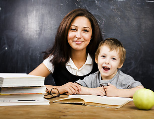 Image showing little cute boy with teacher in classroom