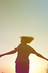 Image showing Silhouette of a dancing woman at sunset.