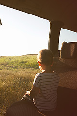 Image showing Child in the car and looks into the distance.