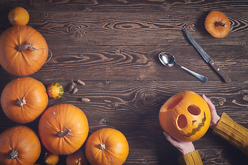 Image showing Hands holding Halloween pumpkin top view