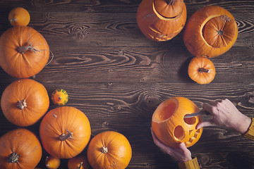 Image showing Ripe yellow pumpkins over wooden background