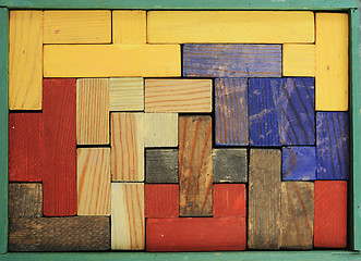 Image showing old wooden multicolored puzzle in box