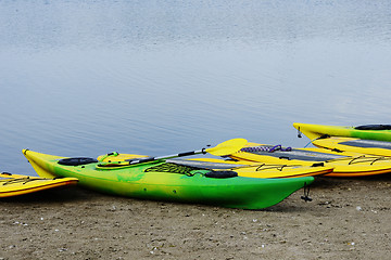 Image showing surfers and kayaks on the beach