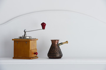 Image showing vintage hand coffee grinder and old arabic coffee pot 