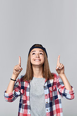 Image showing Teen girl pointing up at empty copy space