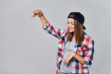 Image showing Teen girl pointing down at empty copy space