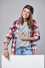 Image showing Teen girl pointing up at empty copy space