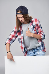 Image showing Teen girl pointing up at empty copy space