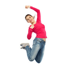 Image showing smiling young woman jumping in air