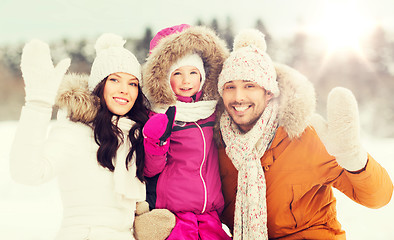 Image showing happy family waving hands outdoors in winter