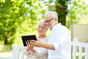 Image showing happy senior couple with tablet pc in city park