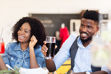 Image showing happy african american couple with drinks at bar