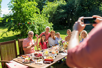 Image showing happy family photographing by smartphone in summer
