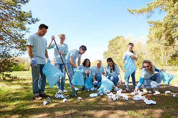 Image showing volunteers with garbage bags cleaning park area