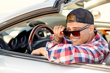 Image showing happy young man in shades driving convertible car