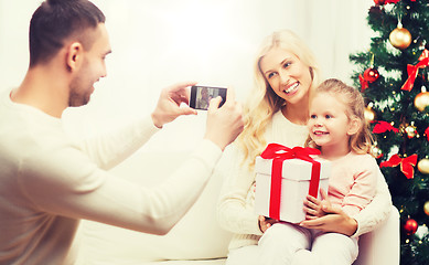 Image showing family taking picture with smartphone at christmas