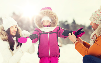 Image showing happy family with child in winter clothes outdoors