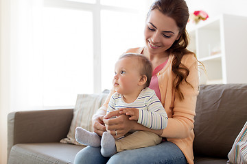 Image showing happy young mother with little baby at home