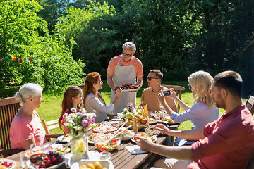 Image showing happy family having dinner or summer garden party