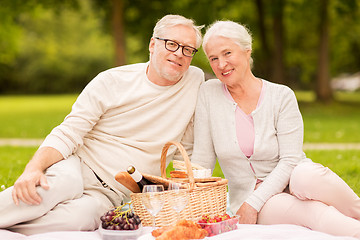 Image showing happy senior couple having picnic at summer park