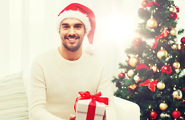 Image showing happy man with christmas gift box at home