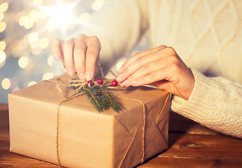 Image showing close up of woman with christmas gift or parcel