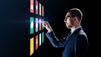 Image showing businessman with menu icons on virtual screen