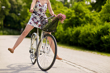 Image showing happy woman riding fixie bicycle in summer park