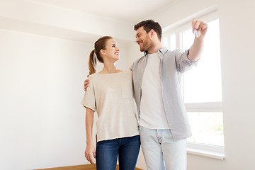 Image showing happy couple with keys of new home