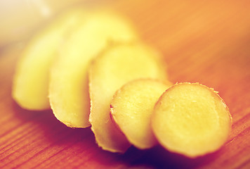 Image showing close up of ginger root on wooden table