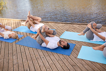 Image showing group of people making yoga exercises outdoors