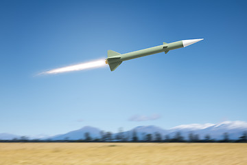 Image showing nuclear rocket bomb flying over a landscape field