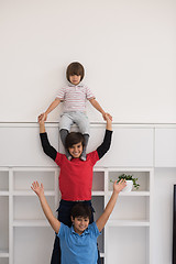 Image showing young boys posing line up piggyback