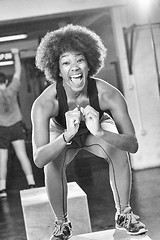 Image showing black female athlete is performing box jumps at gym