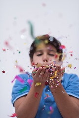 Image showing kid blowing confetti