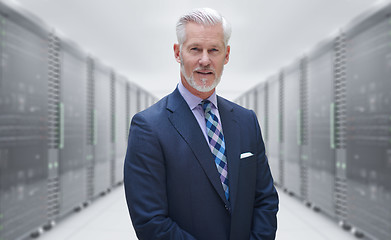 Image showing Senior businessman in server room